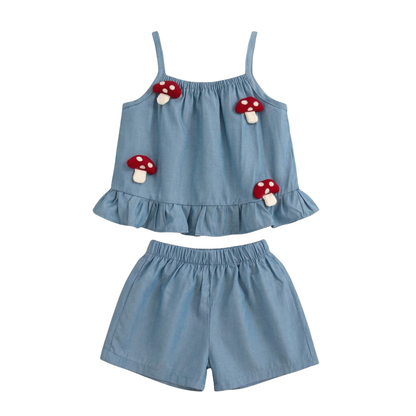 Baby and toddler girl two-piece blue cotton set featuring 3D red mushroom patches on a ruffle camisole top and matching shorts.