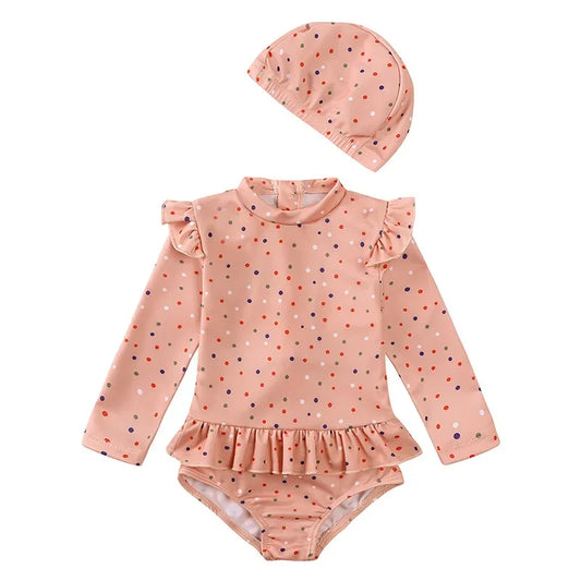 Toddler girl long sleeve swimsuit in Desert Rose Confetti pink with multi-color dots and matching sun hat.