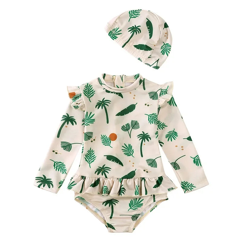 Sage green Isla Palm print toddler girl long sleeve swimsuit set with tropical fronds and ruffle trim.