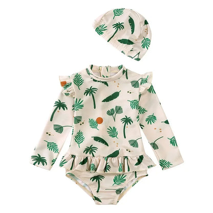 Sage green Isla Palm print toddler girl long sleeve swimsuit set with tropical fronds and ruffle trim.