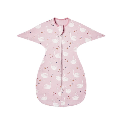 Flat lay of pink cotton swaddle transition bag with white elegant swan pattern and heart details.