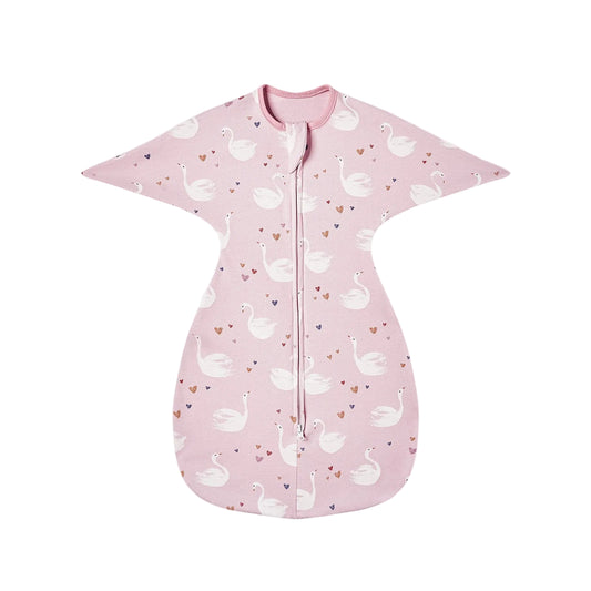Flat lay of pink cotton swaddle transition bag with white elegant swan pattern and heart details.