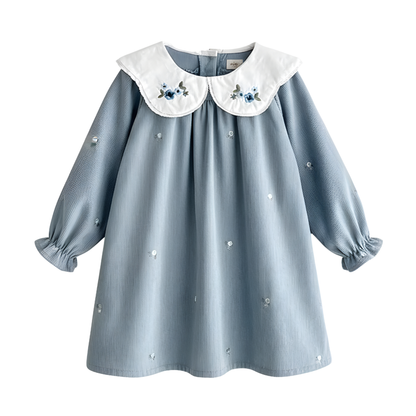 Flat lay of a cottagecore vintage style light blue corduroy A-line Princess Dress with white floral embroidered collars.