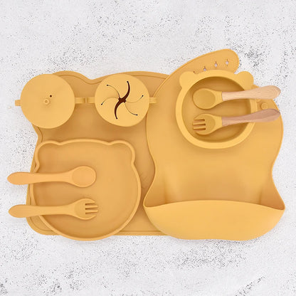 Yellow silicone placemat with cutlery on a textured white background