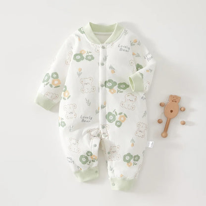 White cotton baby romper featuring a cute green bear and floral print with "Lovely Bear" text. Long sleeve infant jumpsuit with green ribbed cuffs and snap-front closure.