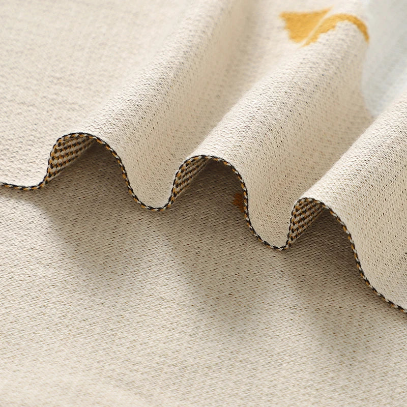 Close-up of textured beige fabric with a scalloped edge