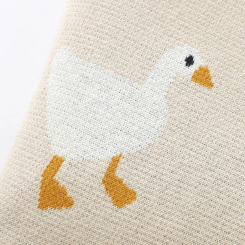 Close-up of a textured fabric with a goose design on a beige background
