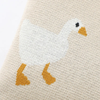 Close-up of a textured fabric with a goose design on a beige background