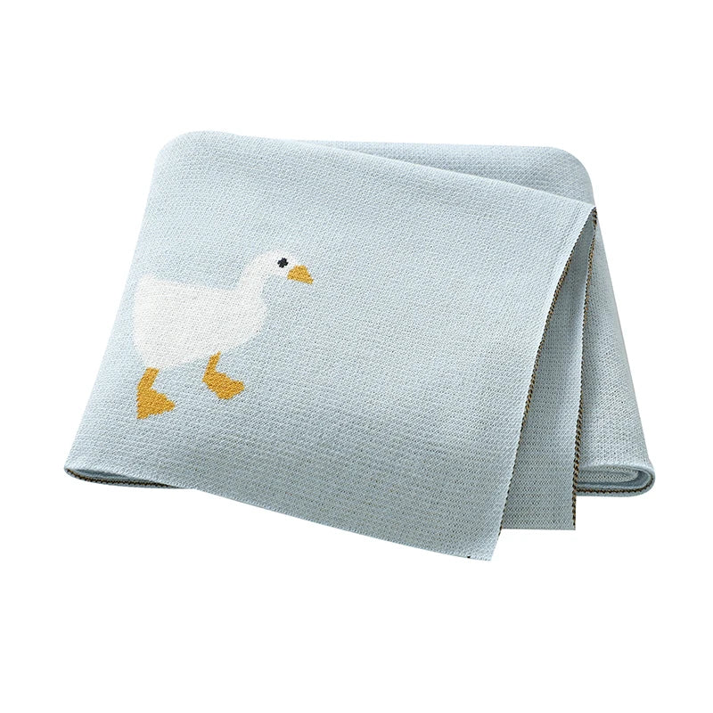 Folded light blue towel with a goose design on a white background