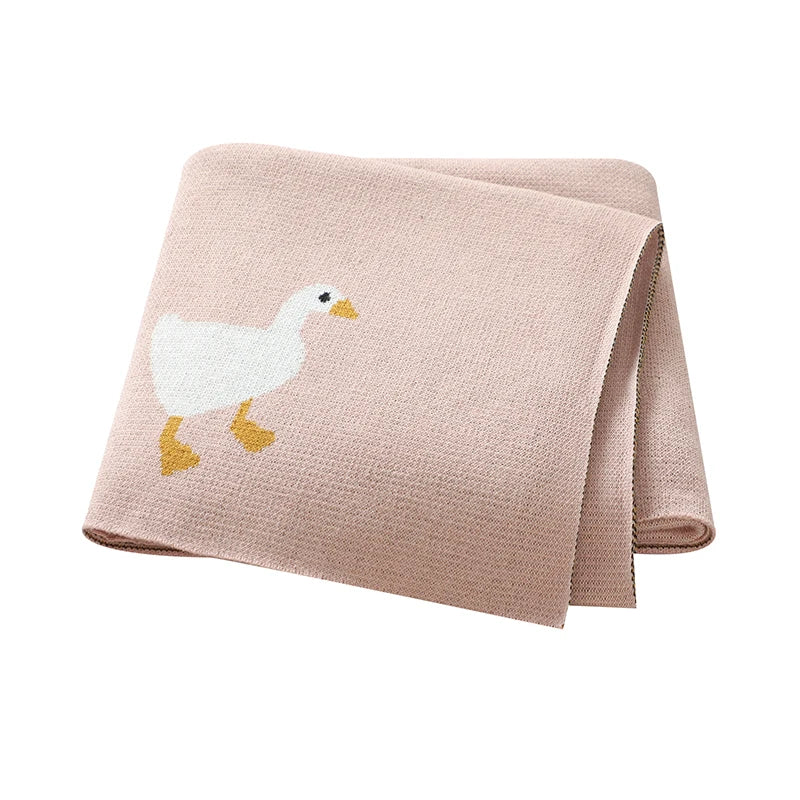 Pink blanket with a goose design on a white background