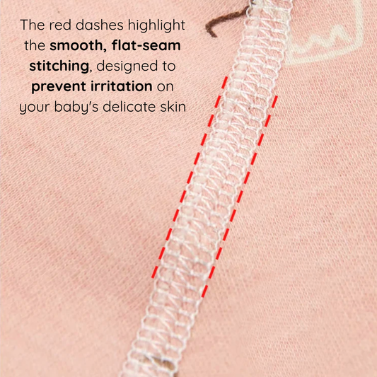 Close-up detail of the smooth, flat-seam stitching on the pink cotton fabric, designed to prevent irritation on delicate newborn skin.
