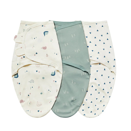 Forest Friends swaddle trio with snail and hedgehog print, sage green trees, and blue triangles.