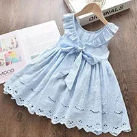 Back view of a light blue girls party dress showing the elegant V-cut back with a large matching fabric bow and ruffled shoulders.