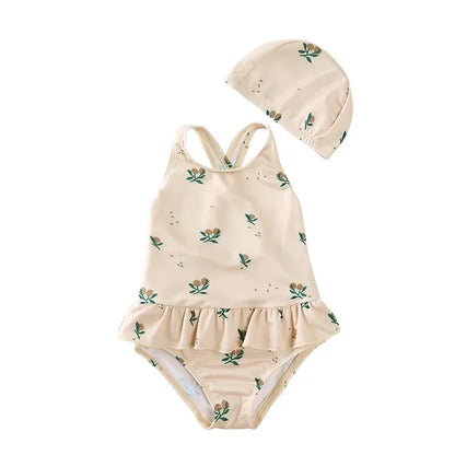 Boho girls cross-back swimsuit in Harvest Olive with delicate botanical print and matching sun cap.