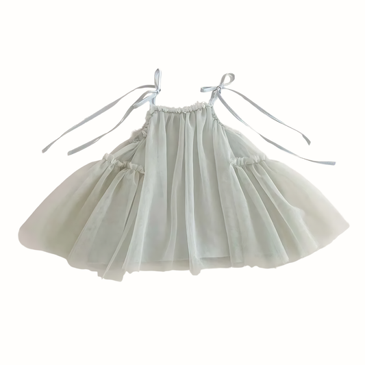 Flat lay of girls' mesh tulle strap dresses in dusty sage green, featuring a tiered fairy silhouette and adjustable cottagecore-style shoulder ties.