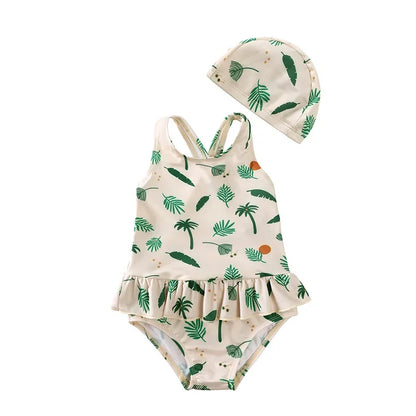 Sage green Isla Palm print girls swimsuit set with tropical leaf pattern and ruffle trim.