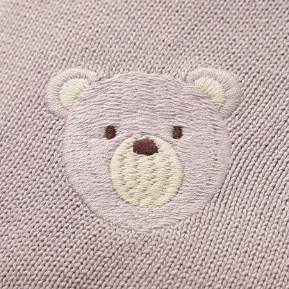 Cute embroidered bear on purple blanket