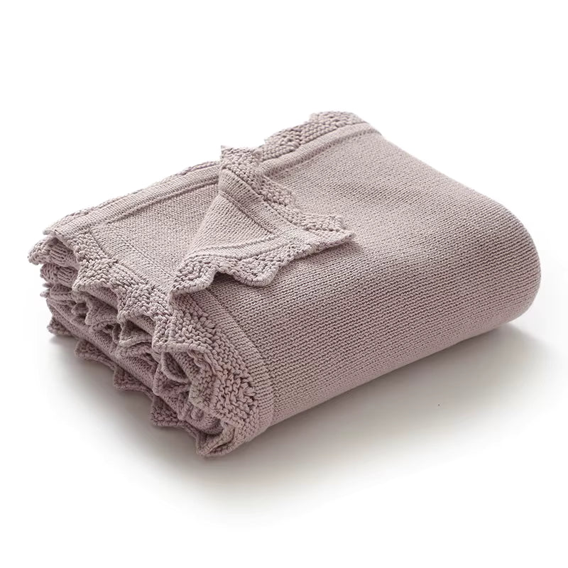 Folded purple knit baby blanket