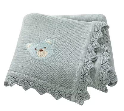 Green knitted blanket with a teddy bear Applique on a white background