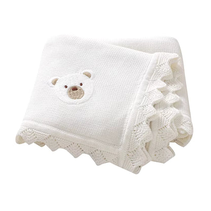 White knitted baby blanket with a teddy bear Applique on a white background