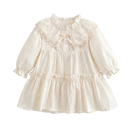 Off-white vintage toddler and girls long sleeve tiered dress featuring an oversized lace Peter Pan collar, bishop sleeves, and front bow detail.