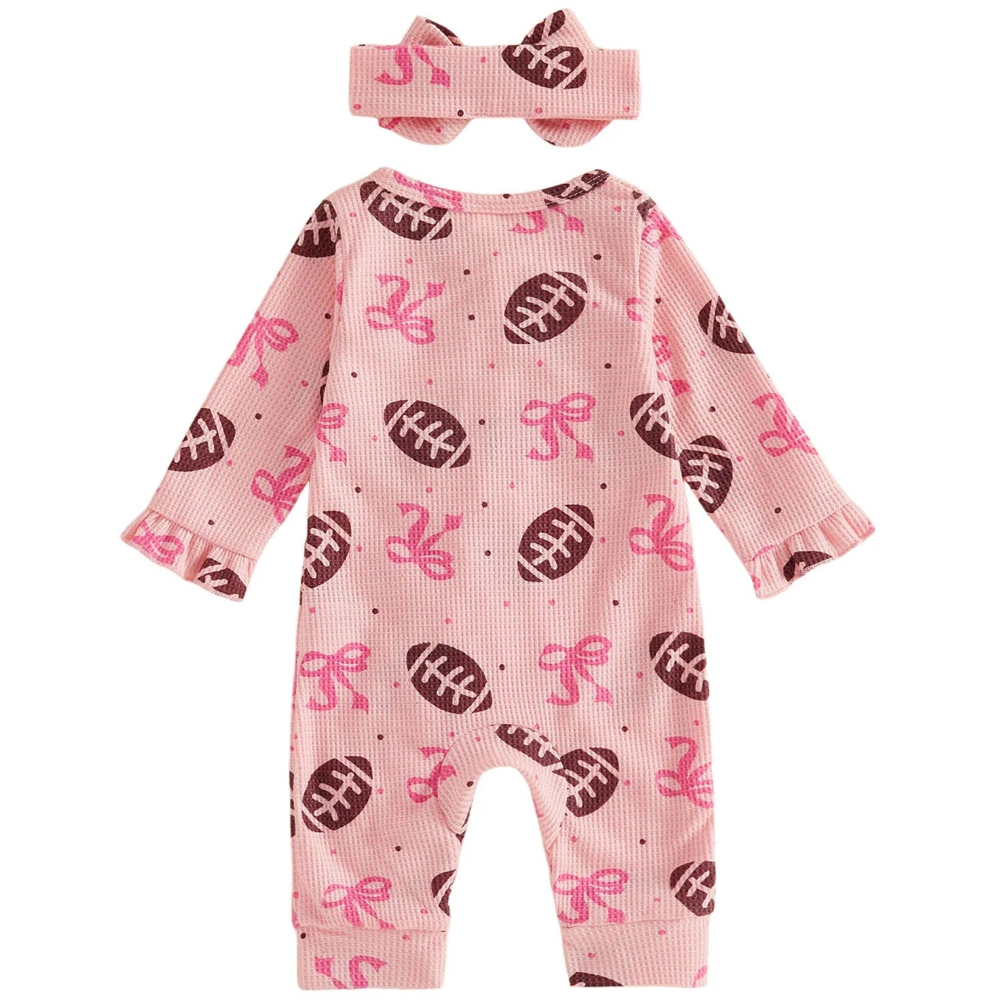 Back view of the pink baby girl long-sleeve jumpsuit and matching bow headband, showing the all-over football pattern.