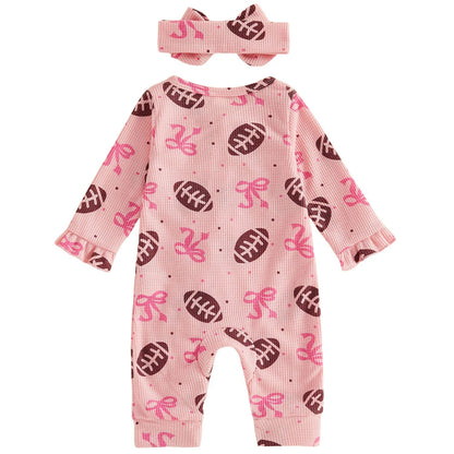 Back view of the pink baby girl long-sleeve jumpsuit and matching bow headband, showing the all-over football pattern.