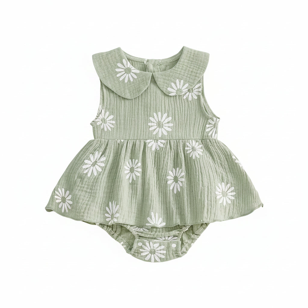 Sleeveless sage green baby girl romper dress with all-over white daisy pattern and ruffled skirt overlay.