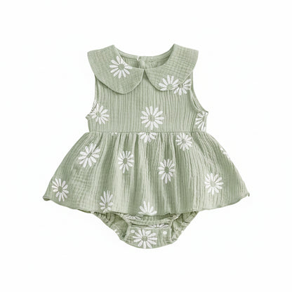 Sleeveless sage green baby girl romper dress with all-over white daisy pattern and ruffled skirt overlay.