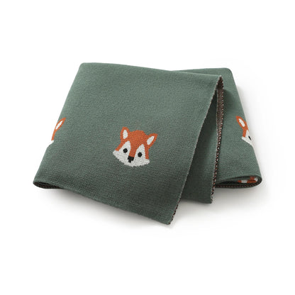 Dark green 100% cotton soft knit baby receiving blanket with fox pattern folded on white background