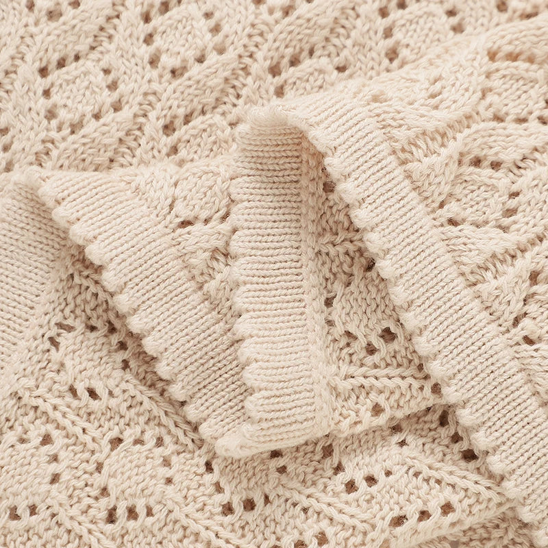 Detailed close-up of ribbed edge stitching on a soft cotton knitted receiving blanket