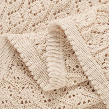 Detailed close-up of ribbed edge stitching on a soft cotton knitted receiving blanket