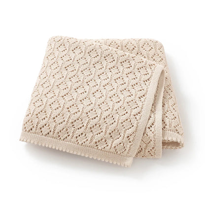 Folded oatmeal 100% cotton soft knit baby blanket displaying open cellular pattern