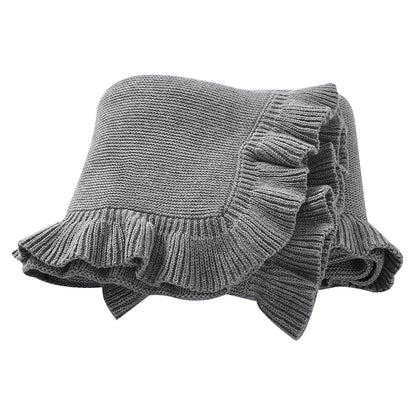 100% cotton knit baby blanket with ruffle edge in dark gray folded on white background