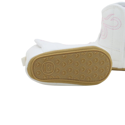 Bottom view of a baby cowgirl boot showing the textured anti-slip paw-print rubber sole.