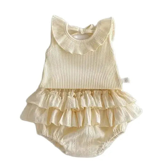 Aria boutique baby girl two-piece matching set in cream featuring a sleeveless ribbed cotton top with a pleated ruffle collar and matching triple-layered ruffle bloomers on a clean white background.