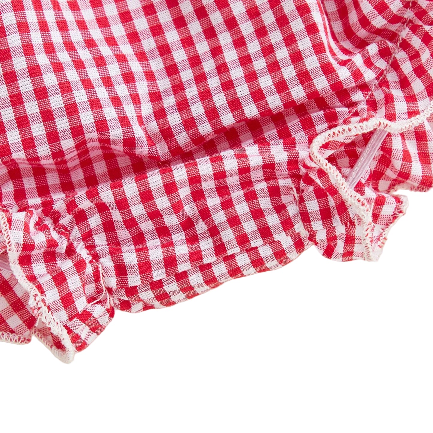 Detailed close-up view of the elasticized ruffled leg opening on the baby girl gingham diaper cover shorts.