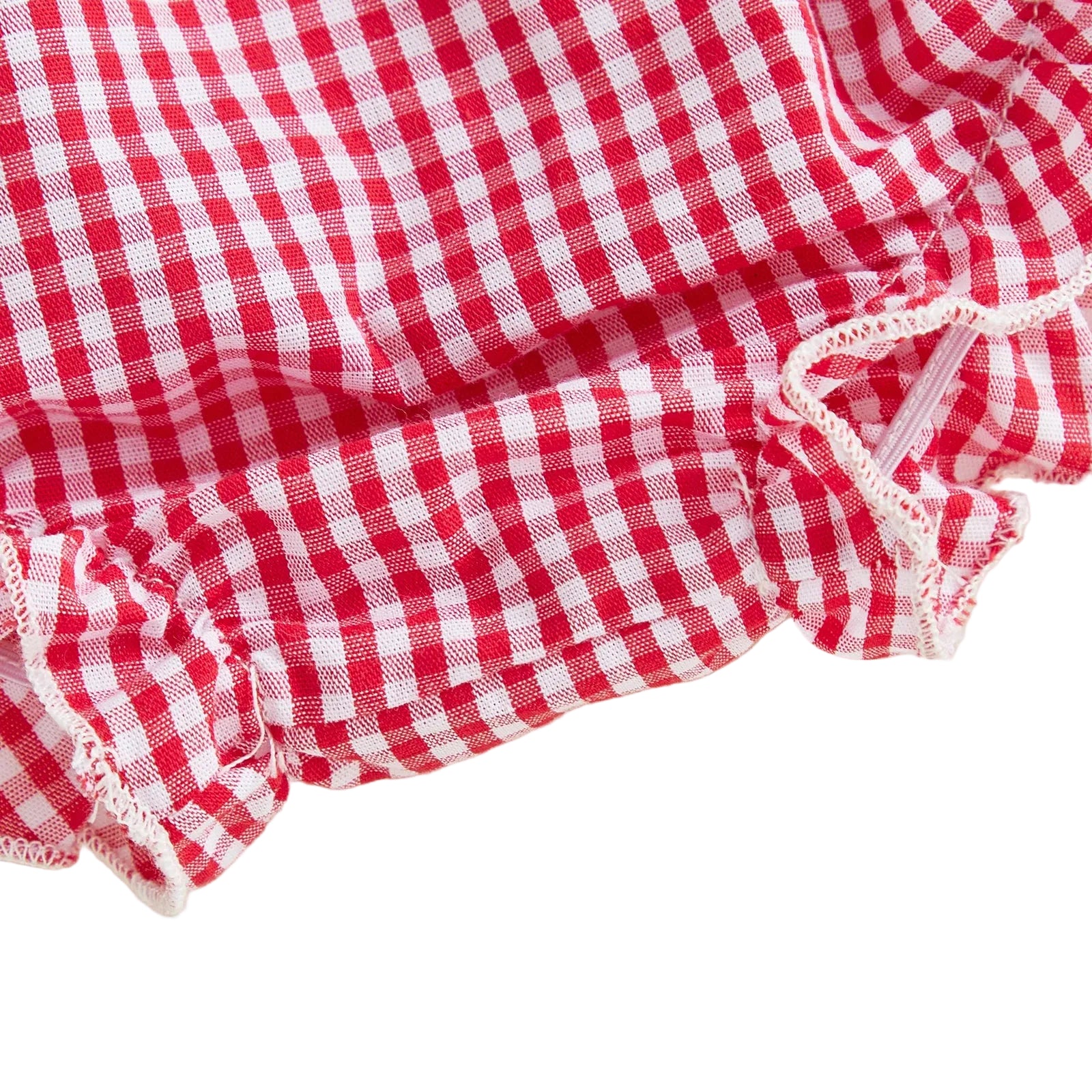 Detailed close-up view of the elasticized ruffled leg opening on the baby girl gingham diaper cover shorts.