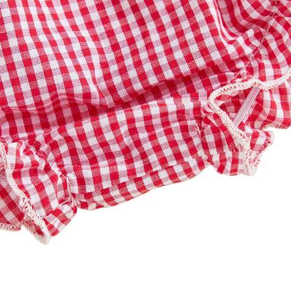 Detailed close-up view of the elasticized ruffled leg opening on the baby girl gingham diaper cover shorts.