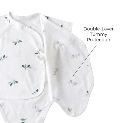 Demonstrating the overlapping kimono panel construction, pointing out the double-layer tummy protection to keep newborns warm.