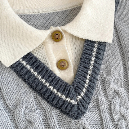 Close-up of ribbed polo collar and faux-wood buttons on baby boy cable knit sweater romper