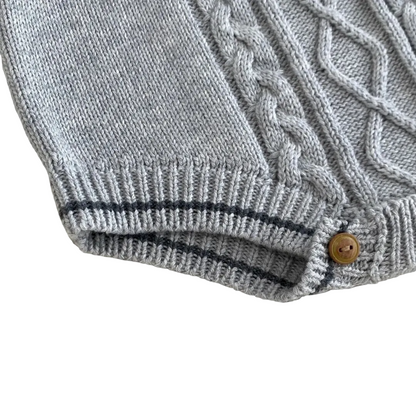 Close-up detail of ribbed cuff leg openings and bottom snap closures for easy diaper changes