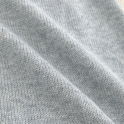 Close-up texture of soft cotton-blend cable knit fabric for baby sweater romper