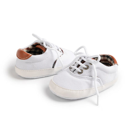 Classic white infant pre-walker sneakers with breathable canvas and adjustable lace-up fit for 0-18M.