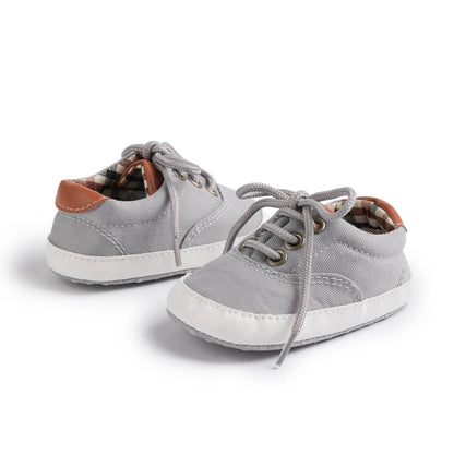 Heather grey soft sole baby sneakers with non-slip grips and vintage heritage plaid lining.
