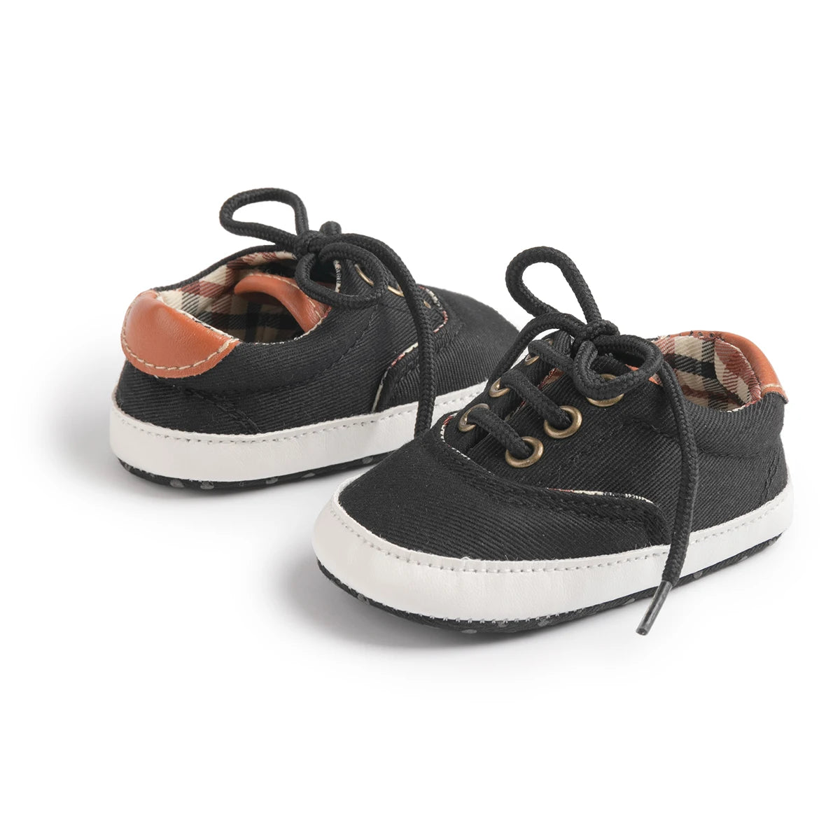 Midnight black baby boy canvas sneakers featuring anti-slip soles and heritage tartan interior lining.
