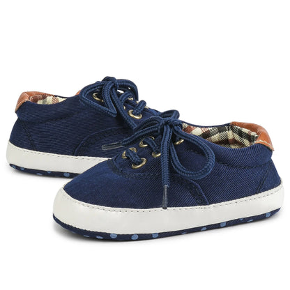 Navy blue infant first walkers with soft flexible soles and tan plaid accents for stylish baby boys.
