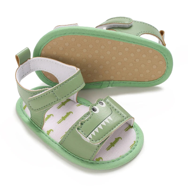 Green infant gator sandals displaying the flexible anti-slip dotted cotton sole.