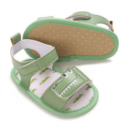 Green infant gator sandals displaying the flexible anti-slip dotted cotton sole.