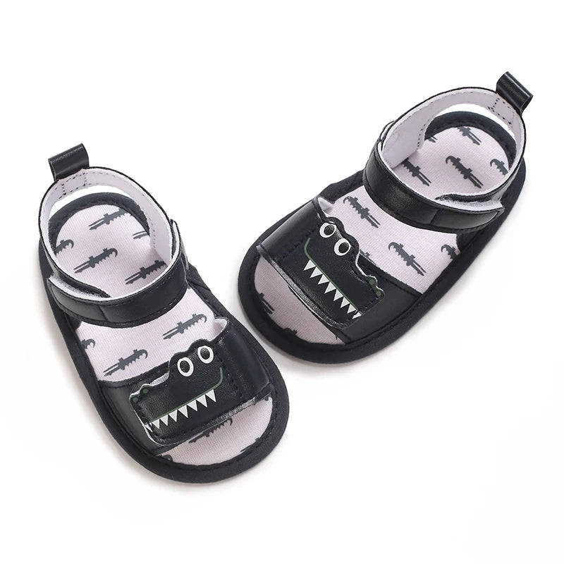 Top-down view of navy blue baby gator sandals showing the inner sole alligator pattern.